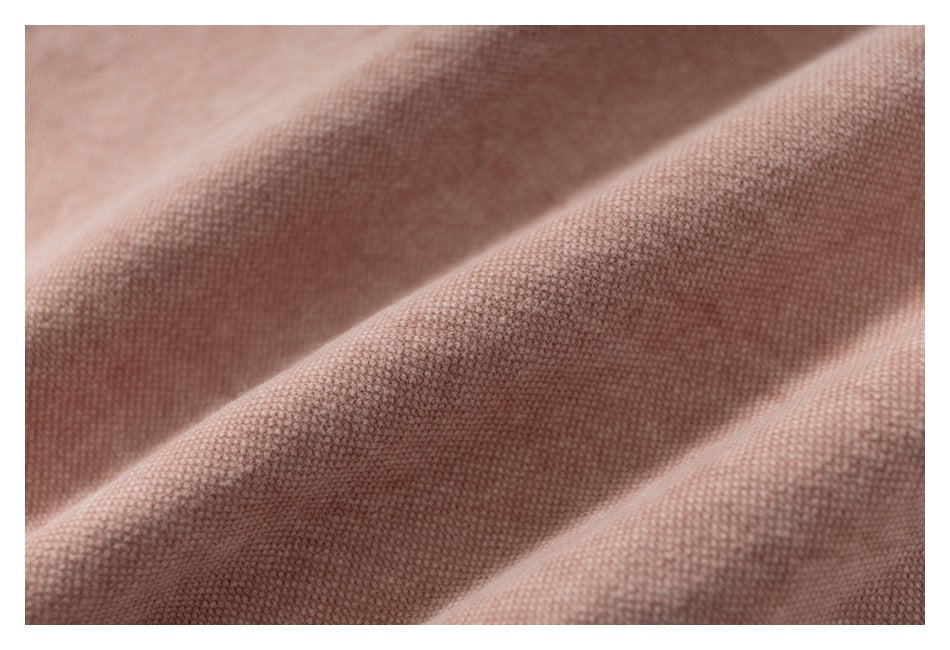 Extreme close-up of the textured dusty rose fabric.