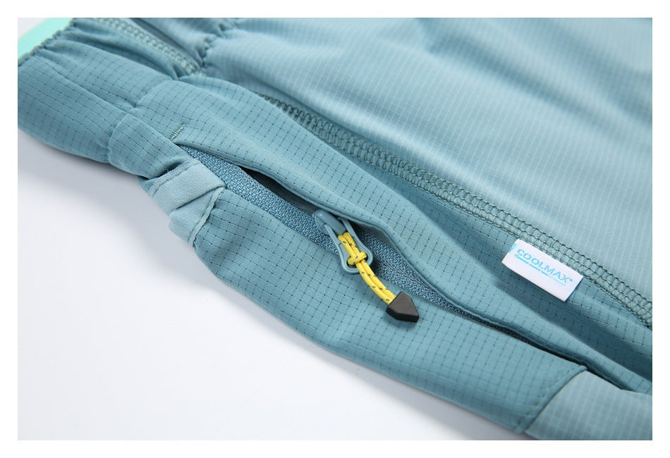 Close-up of a blue-green zippered pocket with yellow pull and COOLMAX label.