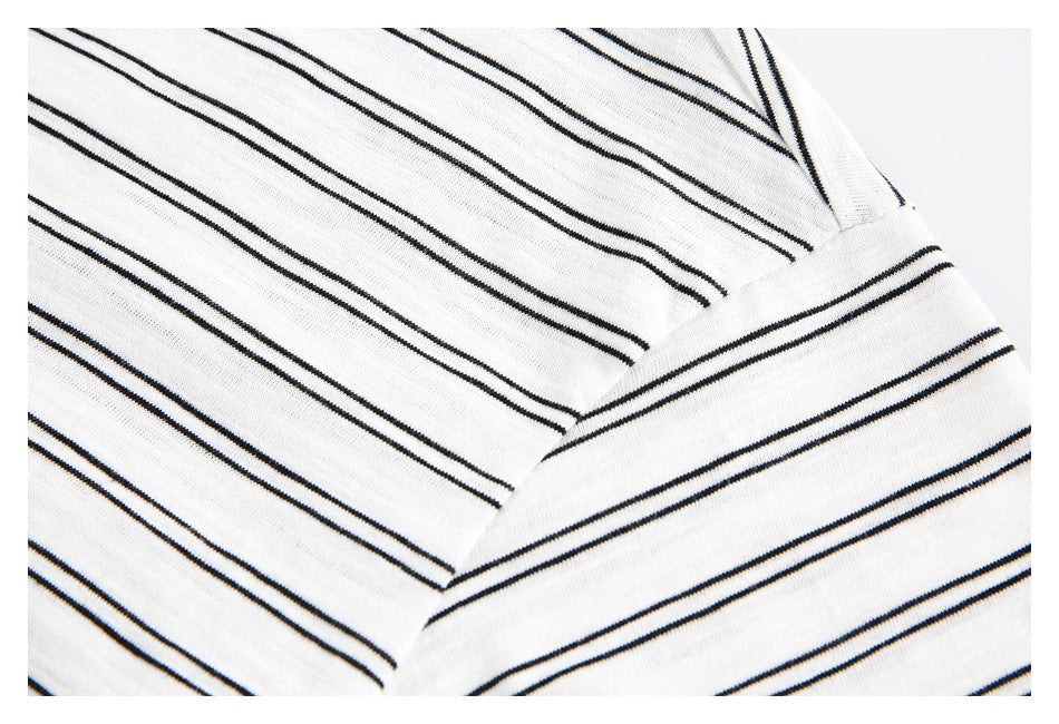 Close-up of the white top's striped sleeve and seam joining it to the body.