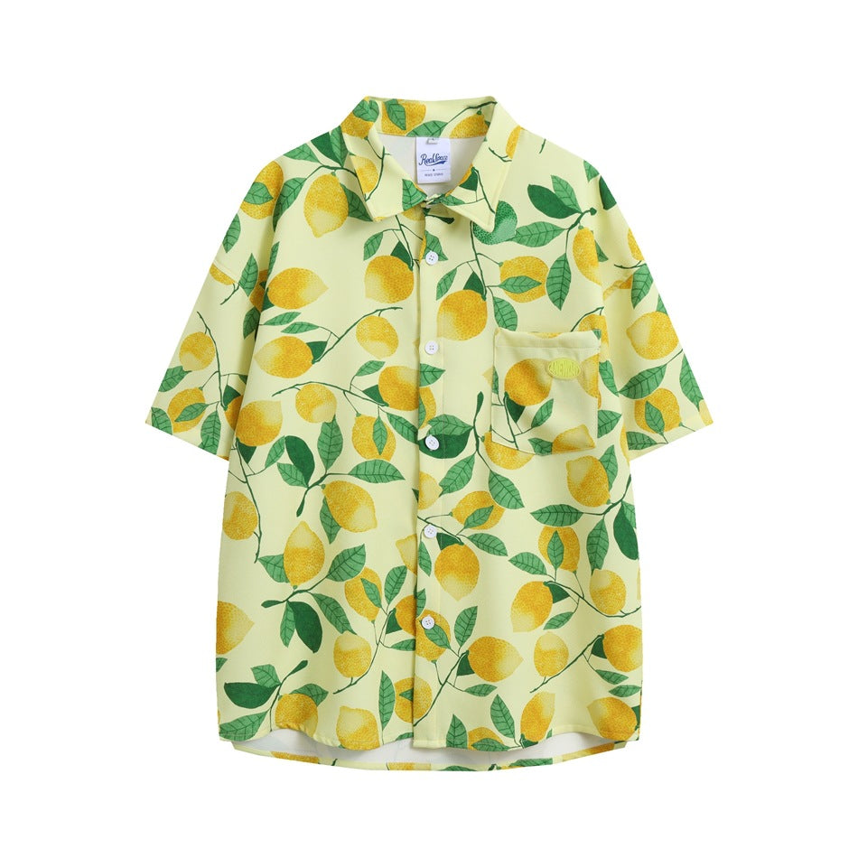 Pale yellow short-sleeve button-up shirt with an all-over yellow lemon and green leaf print and a chest pocket