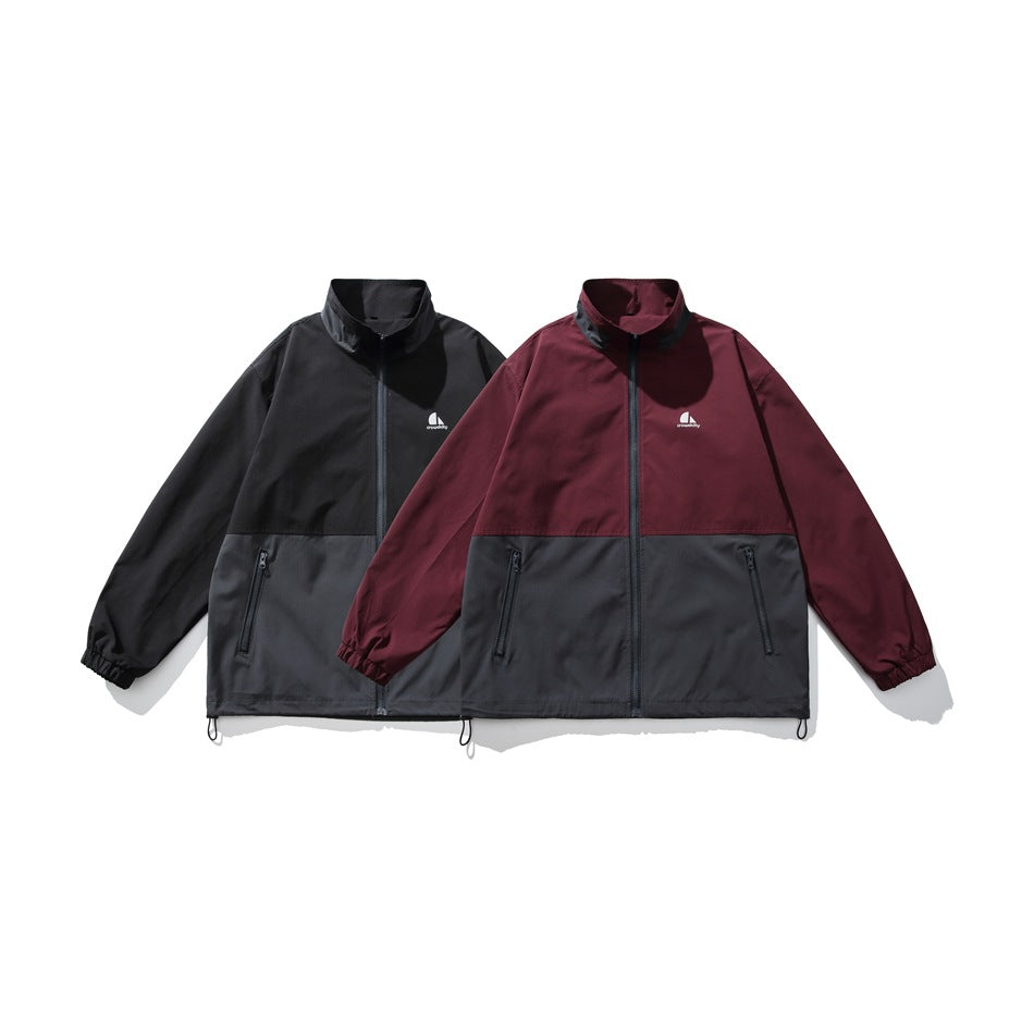Two front-facing colorways of a zip jacket: black and charcoal, and burgundy and charcoal.