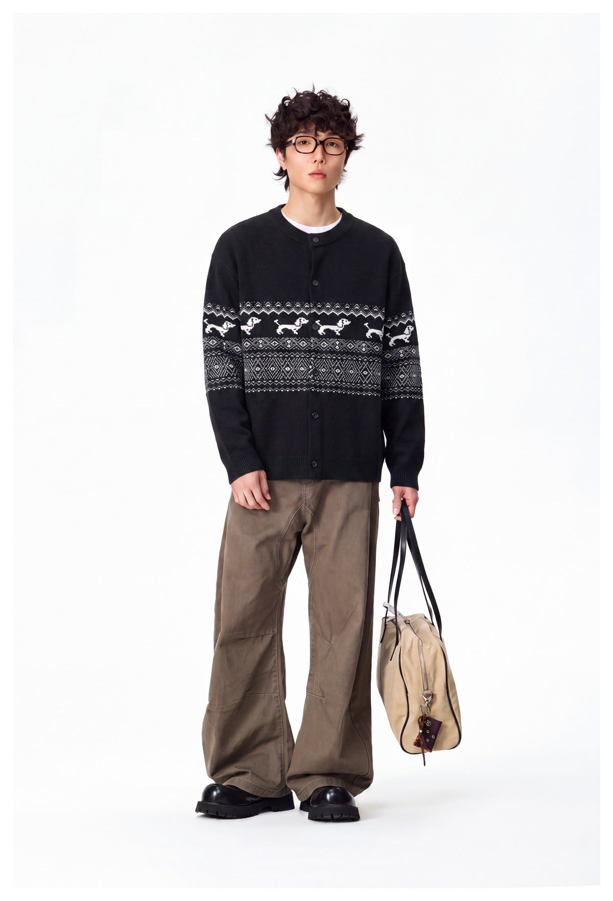 Full-length model wearing a black button-front cardigan with white dog motifs and geometric patterned bands.