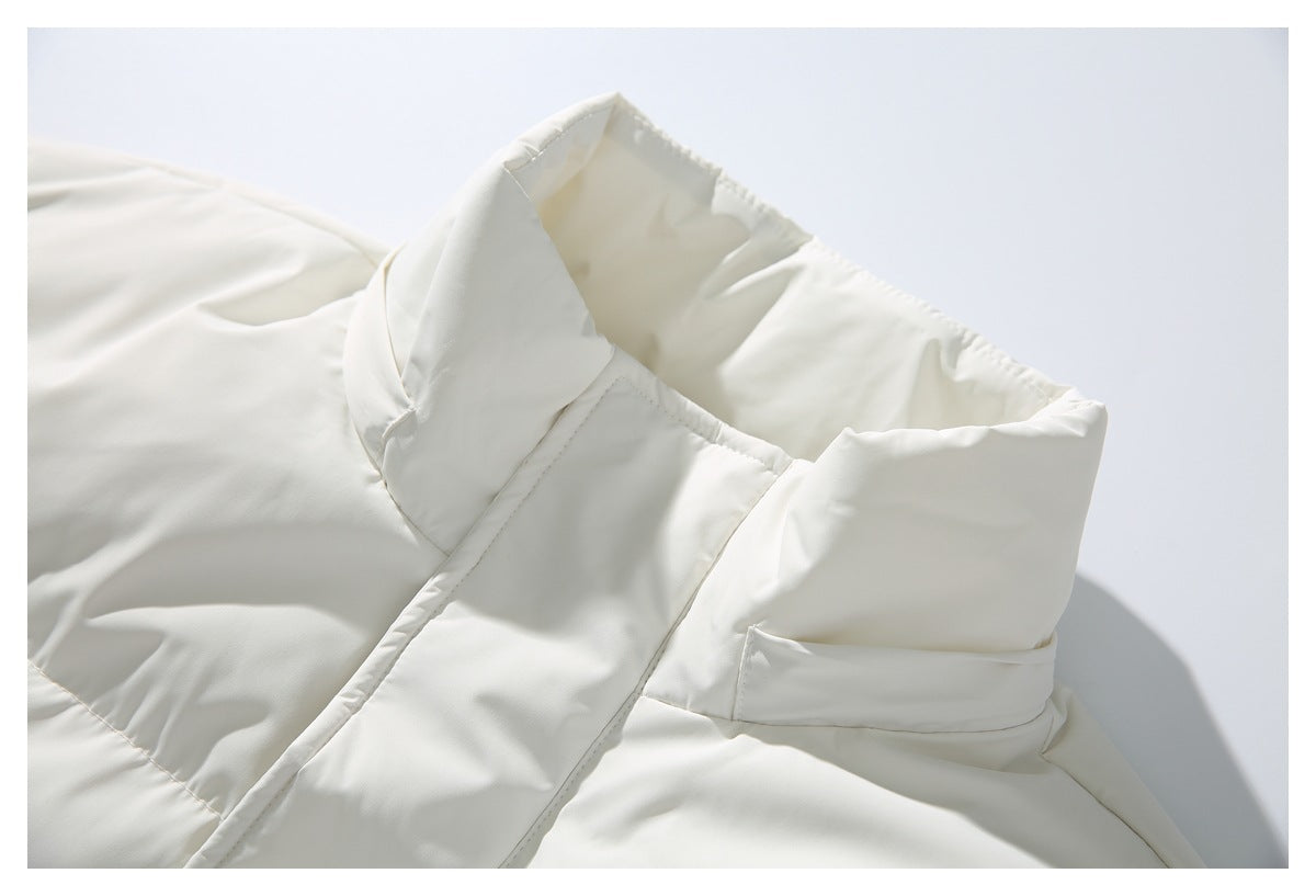 Close-up of a white jacket's wide structured collar and stitched front placket.
