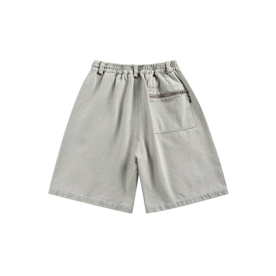 Back view of light gray shorts with an elastic waistband and a zippered patch pocket.