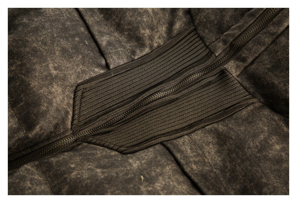 Close-up of a dark zipper running across the jacket's ribbed brown panel and mottled fabric.