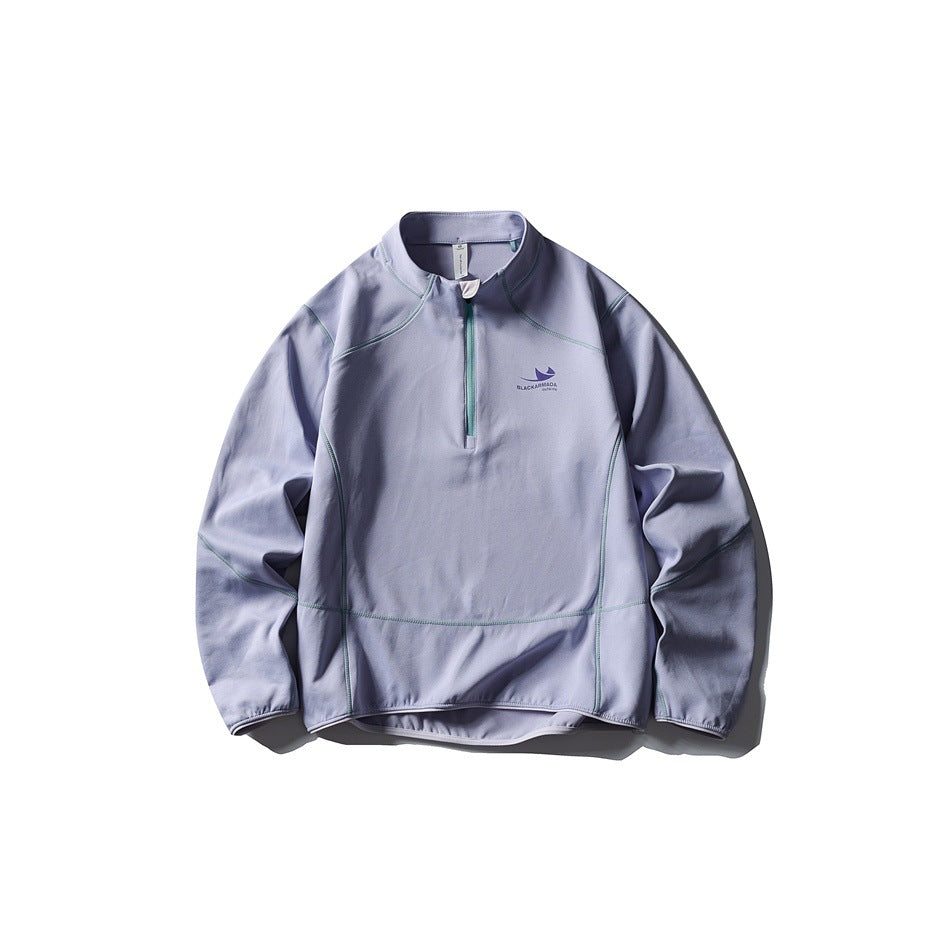 Light purple half-zip pullover flat lay with teal contrast stitching and zipper