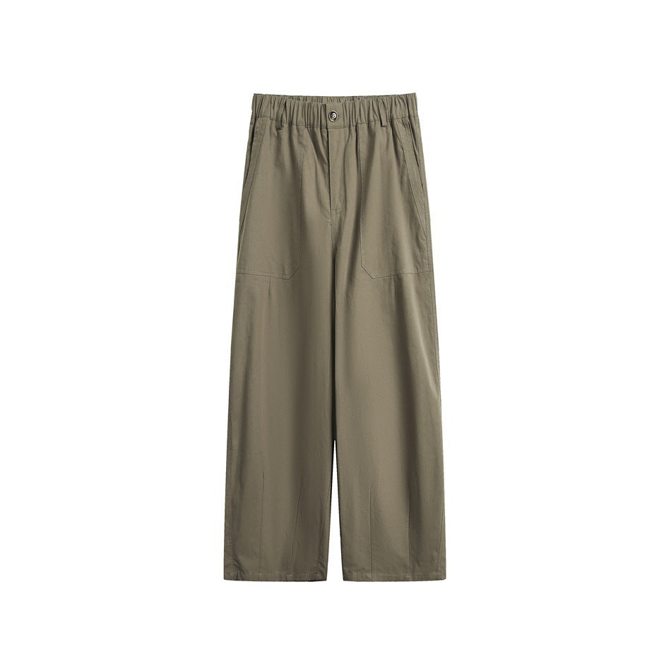Front view of olive-green wide-leg trousers with an elasticated waistband, button closure and two large patch pockets.