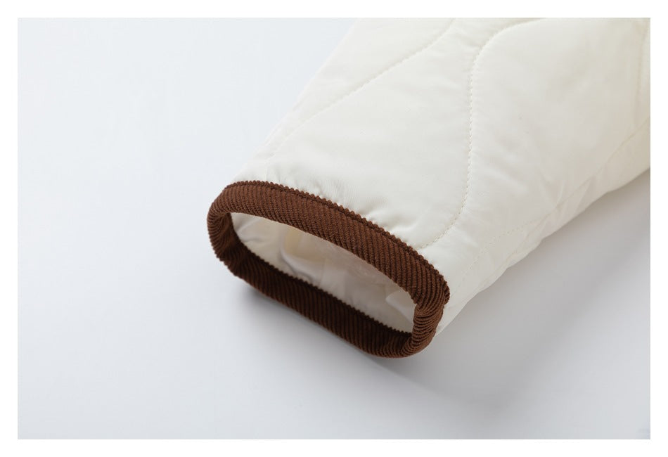 Close-up of the jacket sleeve cuff finished with brown corduroy trim.