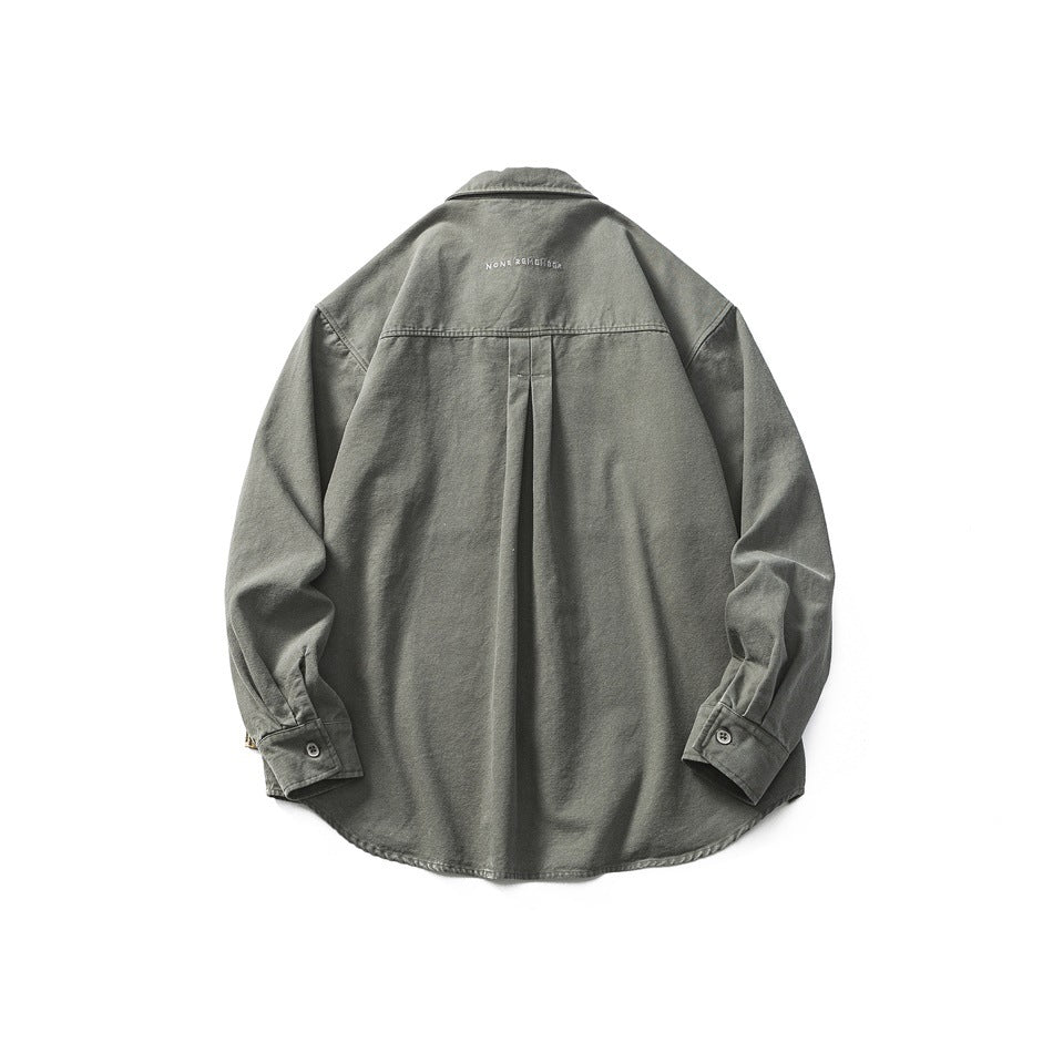 Back view of dark gray-green button-up shirt with center box pleat and small embroidered text below the collar