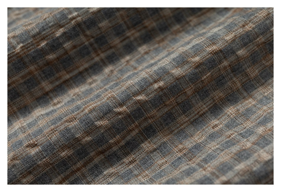 Macro view of the textured gray-brown plaid fabric.