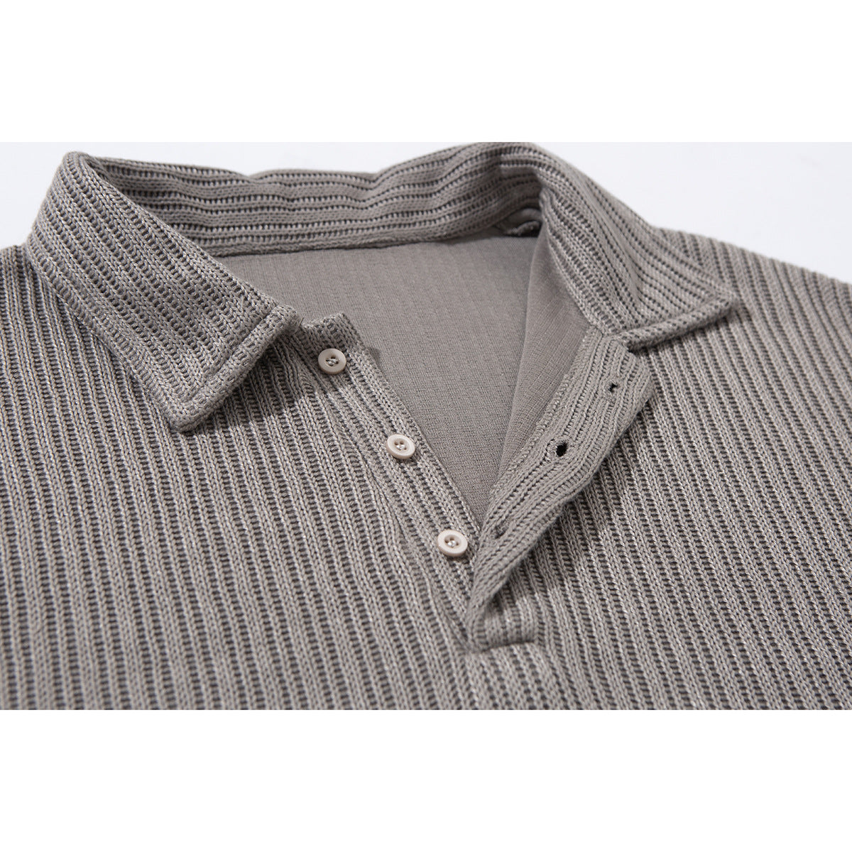 Close-up of a gray rib-knit polo shirt collar and three-button placket.