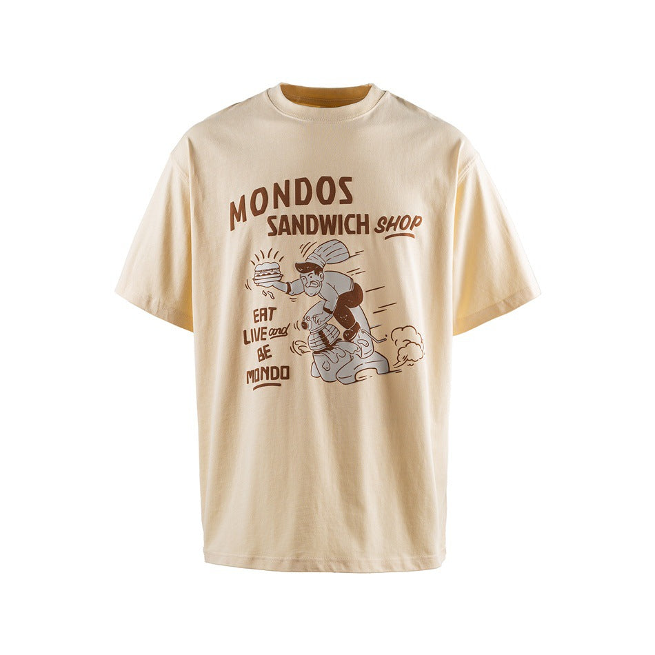 Cream short-sleeve T-shirt with brown sandwich-shop lettering and a cartoon food illustration on the front.