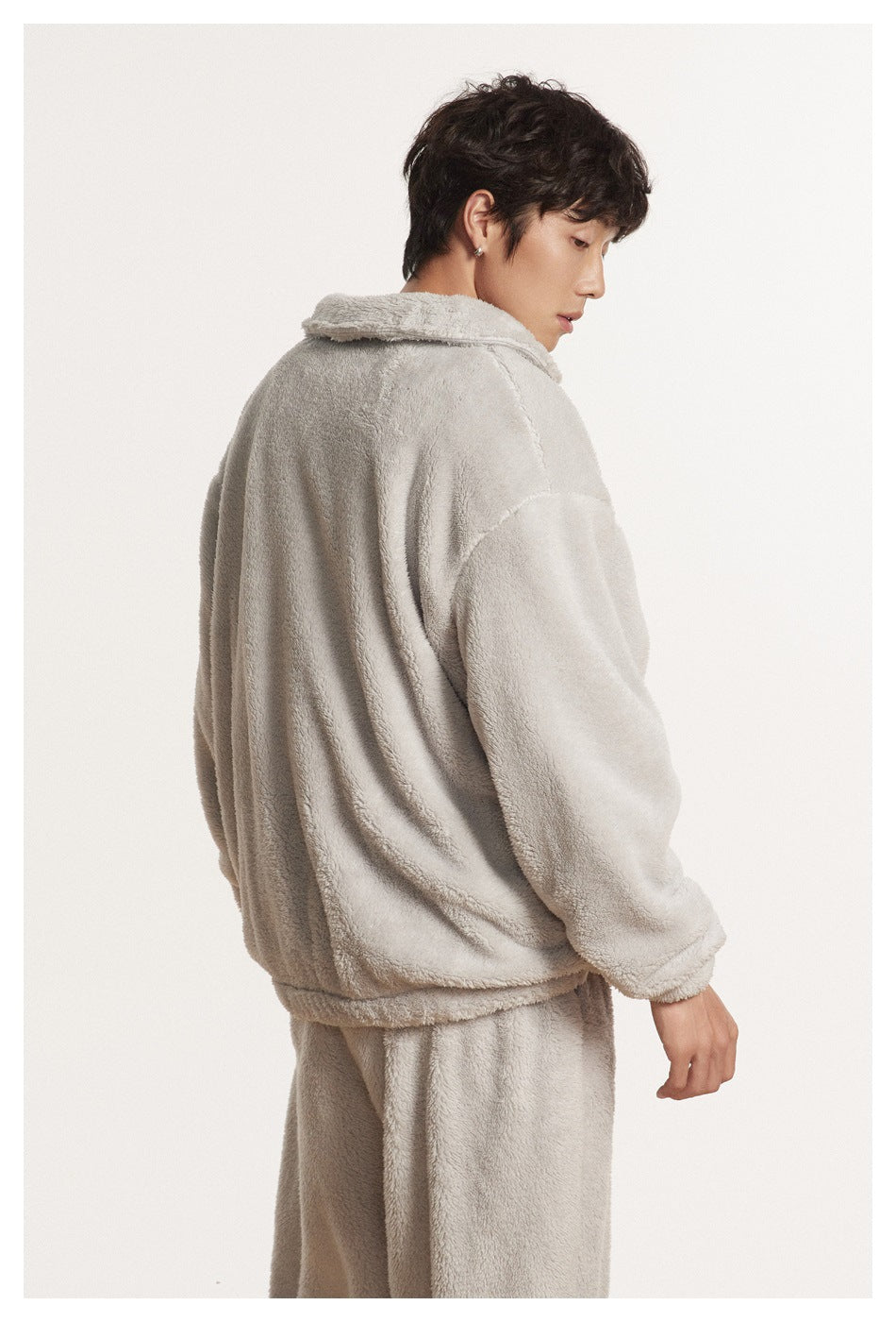 Model shown from the side and back wearing a light gray plush pullover and matching pants.