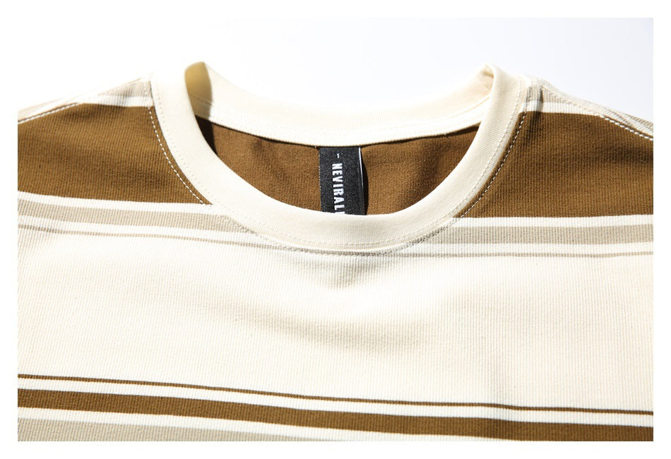 Close-up of a cream-and-brown striped top's ribbed crew neckline and black MAYFAIR neck label.
