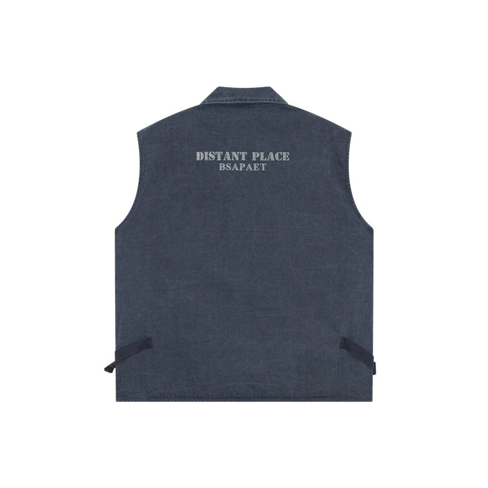 Back of a faded blue sleeveless vest with adjustable side straps and gray “DISTANT PLACE BSAPAET” lettering near the