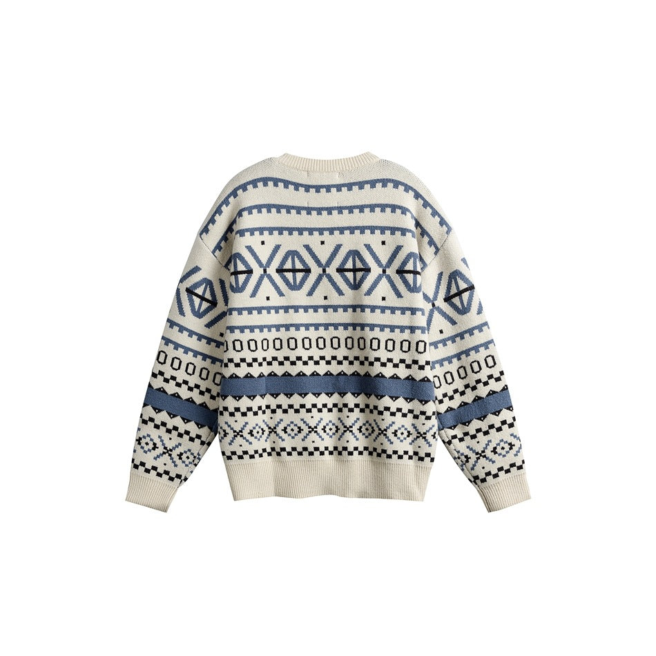 Back view of an ivory crew-neck sweater with blue and black geometric bands and ribbed cuffs and hem.