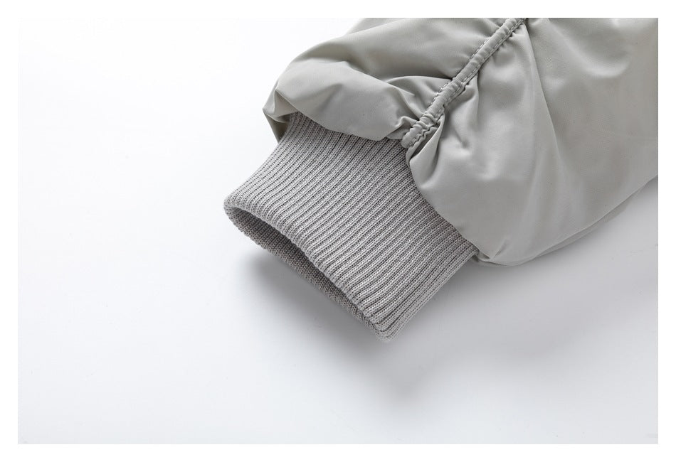 Close-up of the light gray jacket sleeve and ribbed knit cuff.