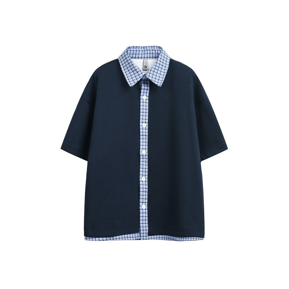 Navy short-sleeve top with blue plaid collar, button placket and hem layer, flat front view