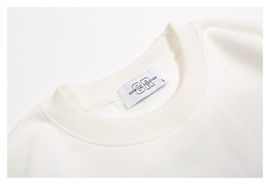 Close-up of the off-white sweatshirt’s ribbed crew neckline and attached English-language neck label.