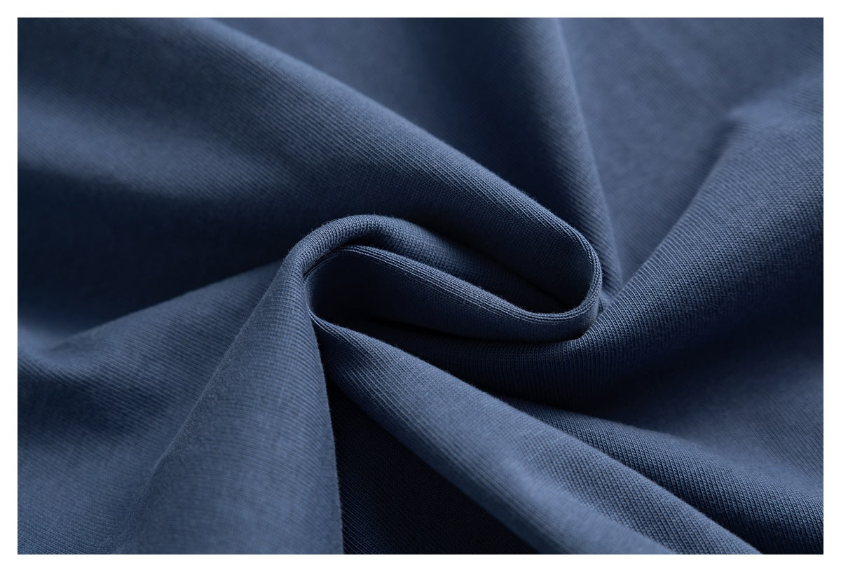 Close-up of dark navy fabric draped in folds, showing a fine ribbed knit texture.