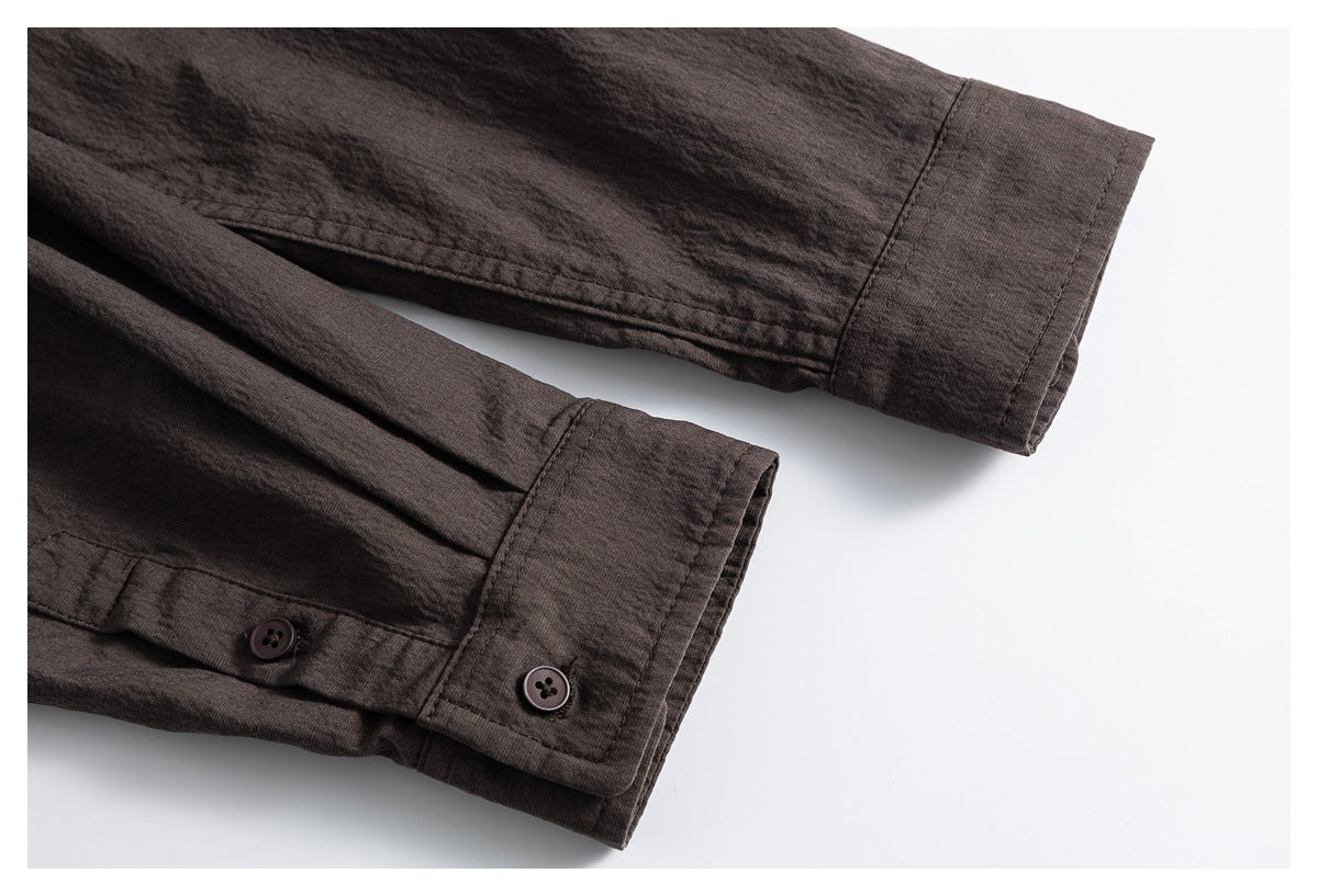 Dark brown shirt sleeve cuffs with button closures, arranged on a white background.