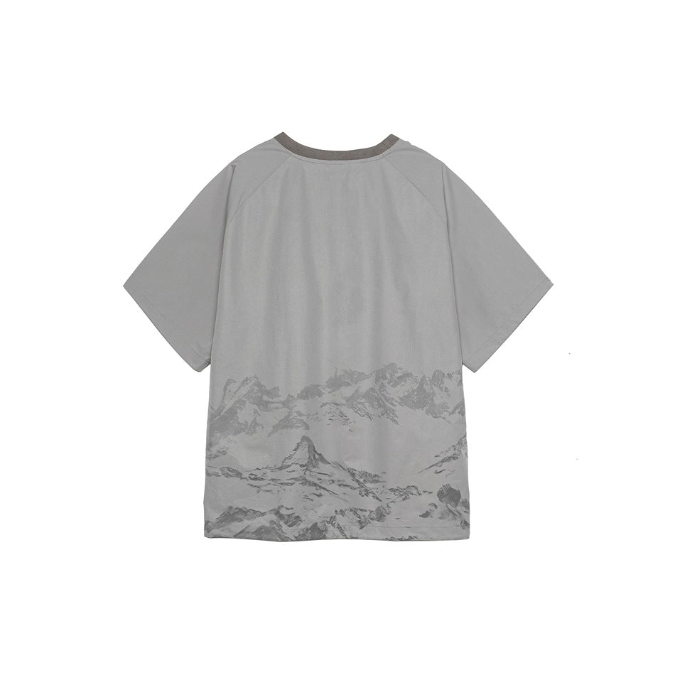 Back view of a gray short-sleeve raglan tee with a mountain print across the lower back and a darker gray collar
