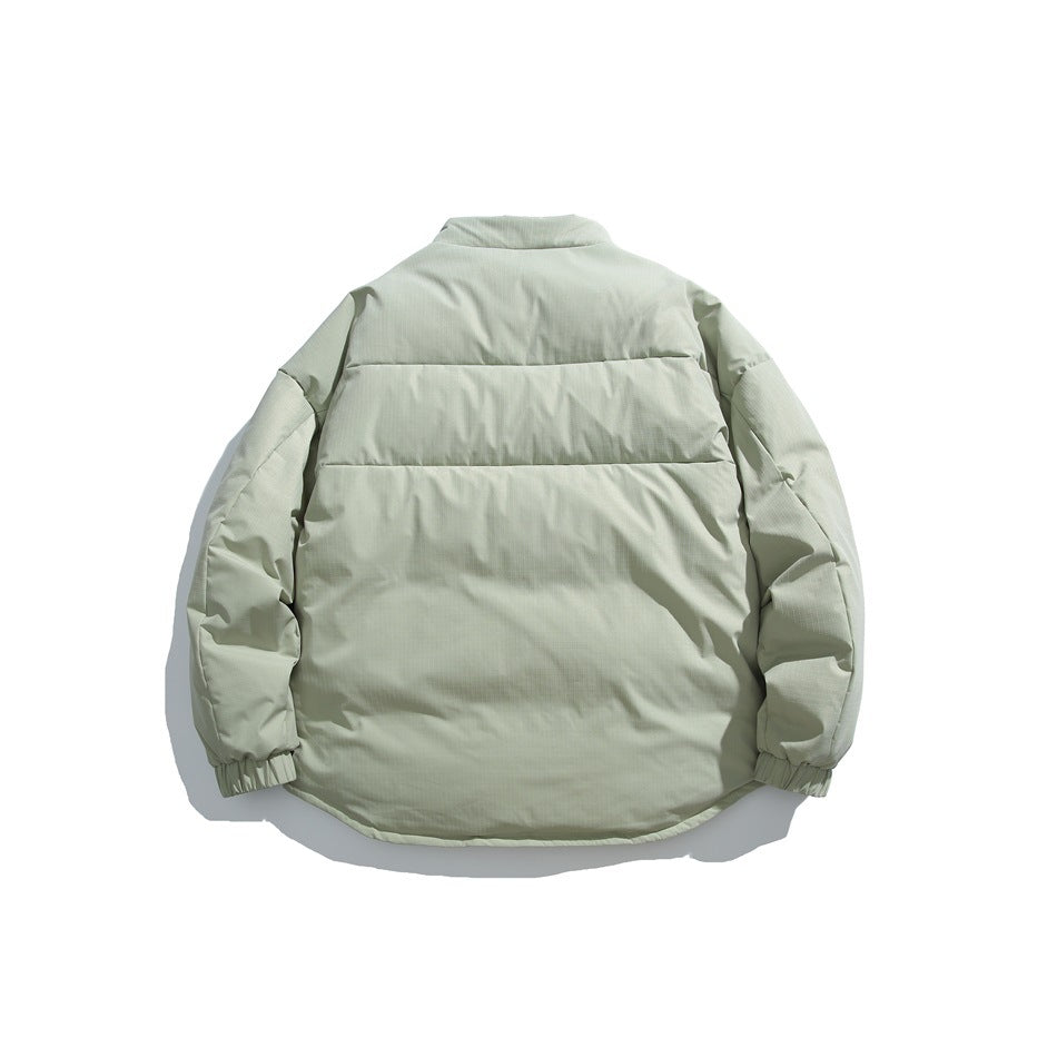 Back view of a pale sage padded jacket with a short stand collar, horizontal panels and elastic cuffs.