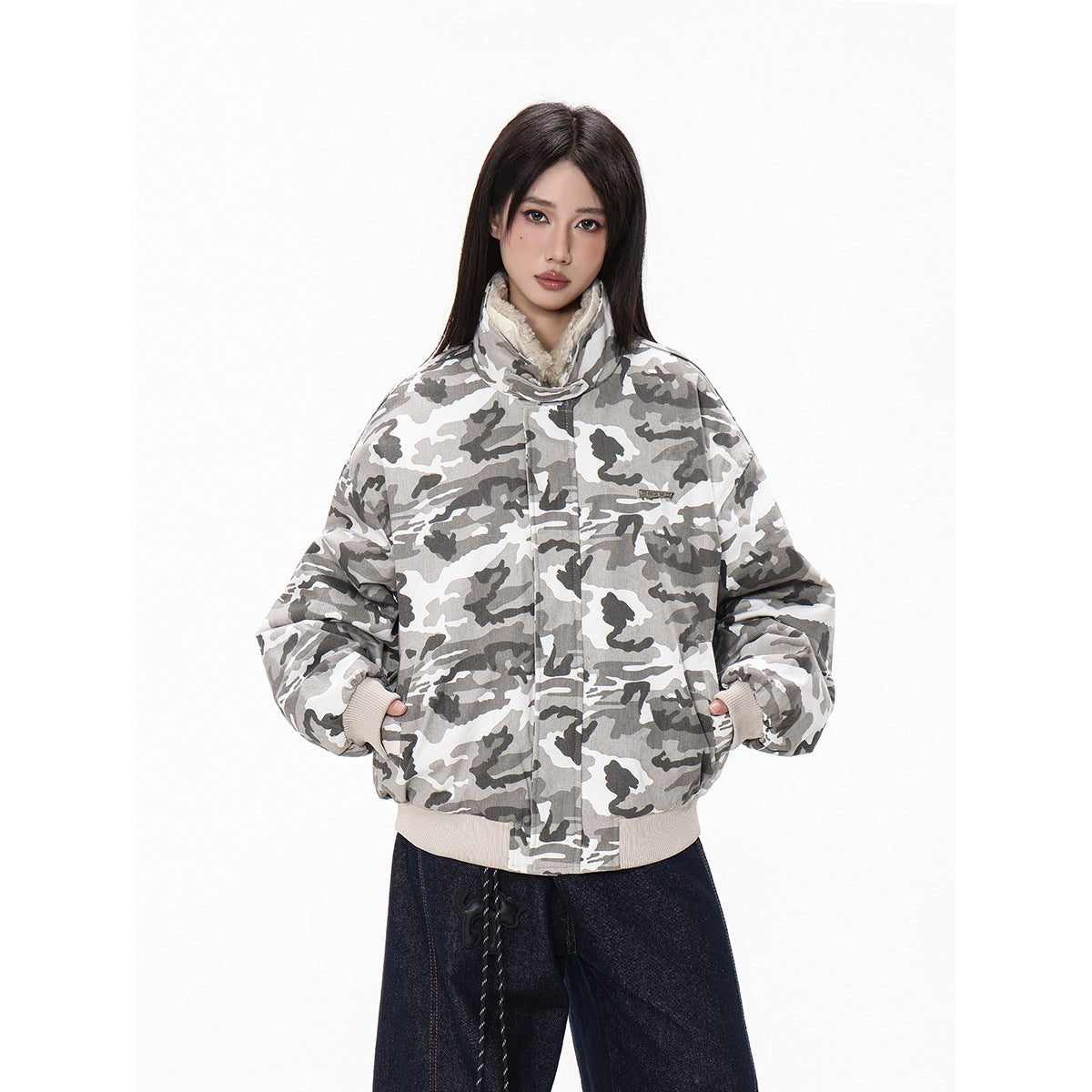 Model wearing a zipped gray-and-white camouflage jacket with a high fleece-lined collar and ribbed cuffs and hem.