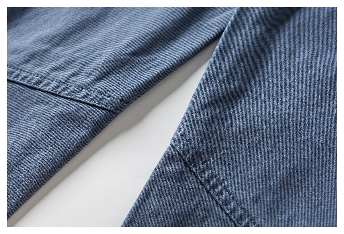 Close-up of the blue-gray pant legs and a stitched seam.