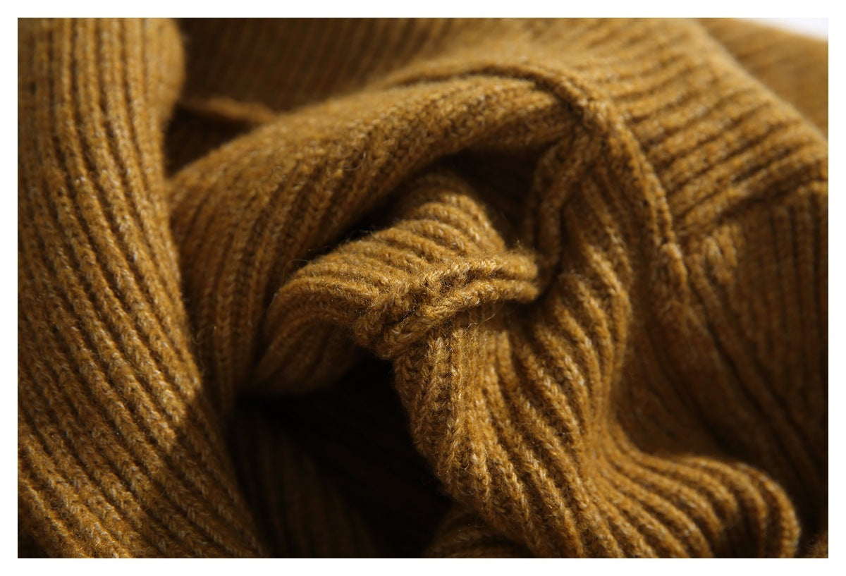 Close-up of warm brown ribbed knit fabric gathered in layered folds.
