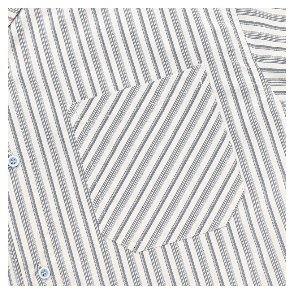 Close-up of a chest pocket with diagonal stripes against the shirt's vertical stripe pattern.