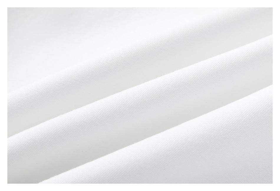 Close-up showing the smooth surface and folds of white garment fabric.