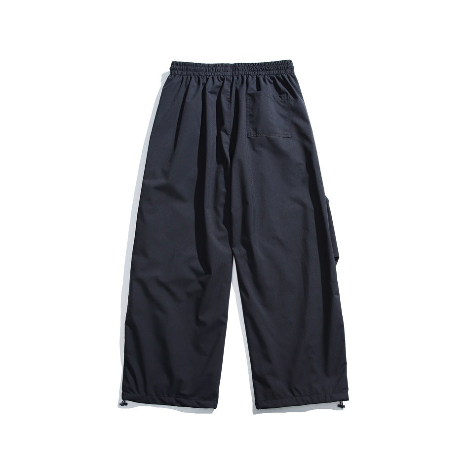 Back view of dark navy wide-leg pants with an elastic waistband, one rear pocket and adjustable ankle hems.