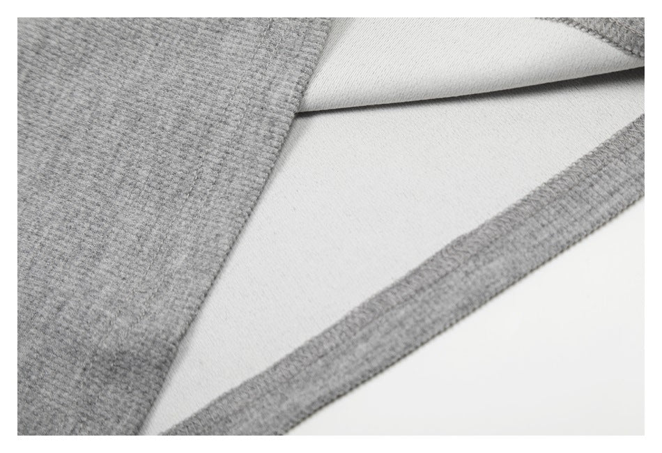 Close-up showing the gray shirt fabric folded back to reveal its lighter underside and edge stitching.