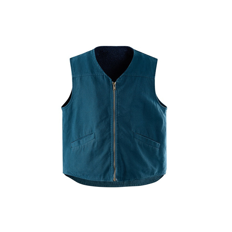 Blue sleeveless zip-front vest with V-neck, angled flap pockets and dark fleece-like lining at the collar