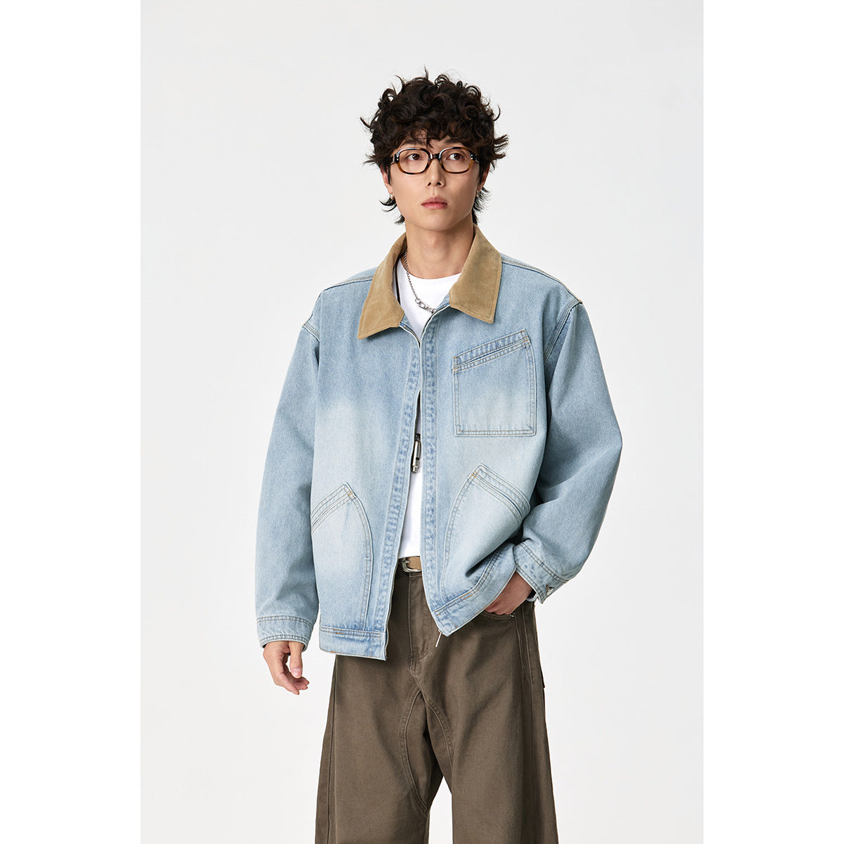 Model standing in a pale blue denim jacket with a tan collar, zip front and three pockets.