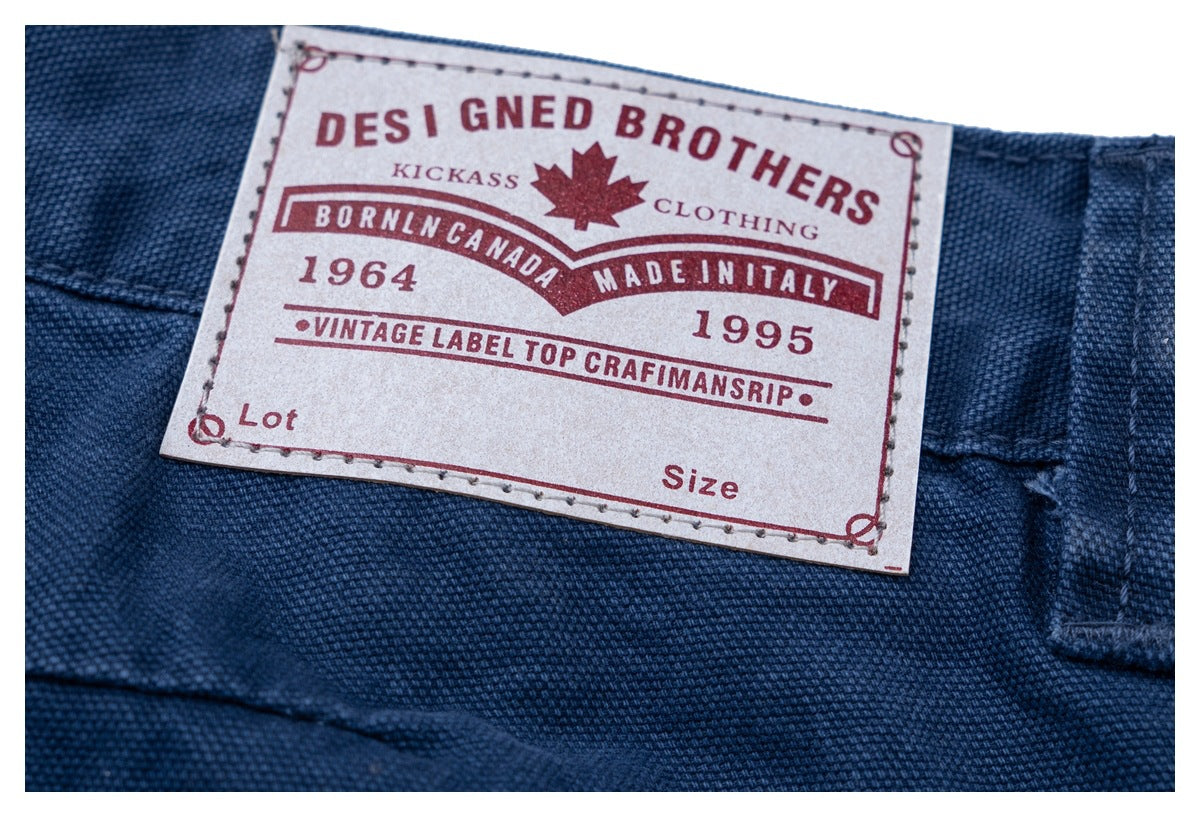 Close-up of a sewn label on dark blue fabric, with English text and a red maple leaf graphic.