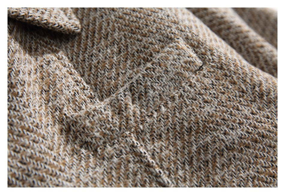 Close-up showing the tan, cream, and dark herringbone weave of the coat fabric.