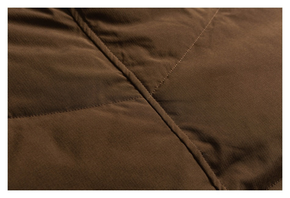 Close-up of brown jacket panels with visible stitching and a raised seam.
