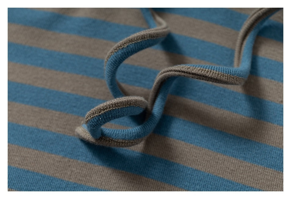 Macro view of a drawstring and blue-and-taupe striped fabric on the hooded top.