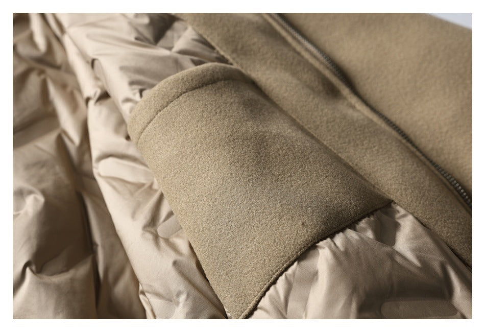 Close-up of the taupe jacket's sleeve, zipper, and light-colored inner lining.