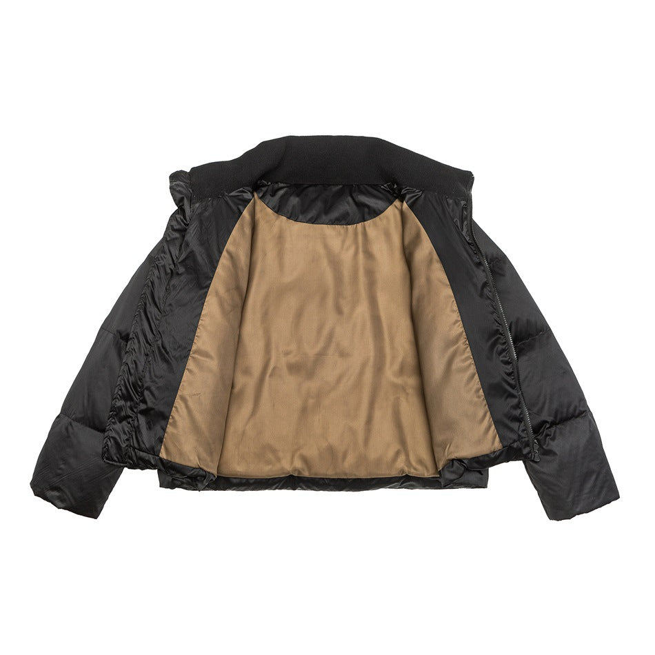 Open black puffer jacket showing tan interior lining, ribbed knit inner collar and zipper placket