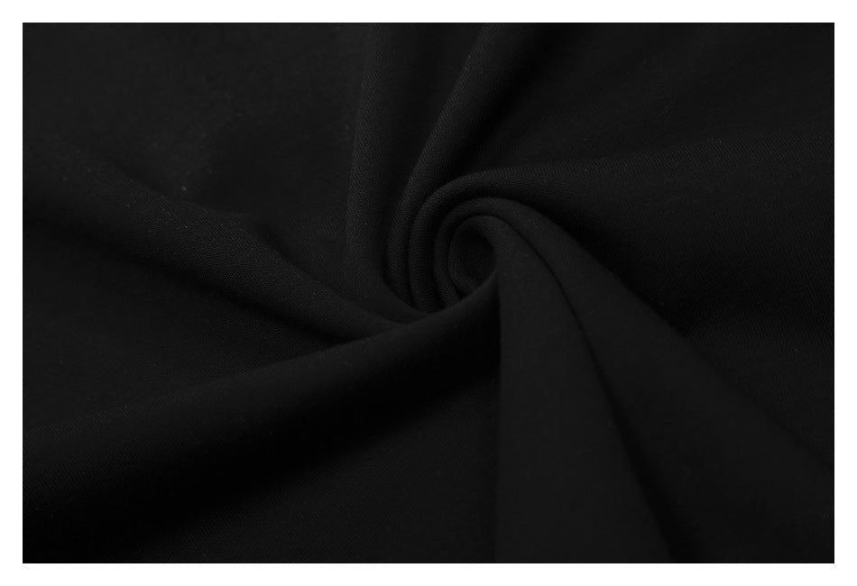 Close-up of black fabric gathered into a soft spiral fold.