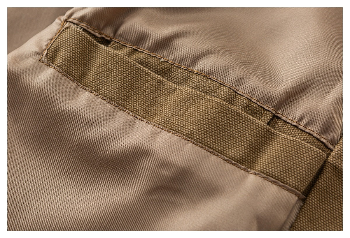 Close-up of the jacket interior, showing a brown textured reinforcement strip on smooth tan lining.