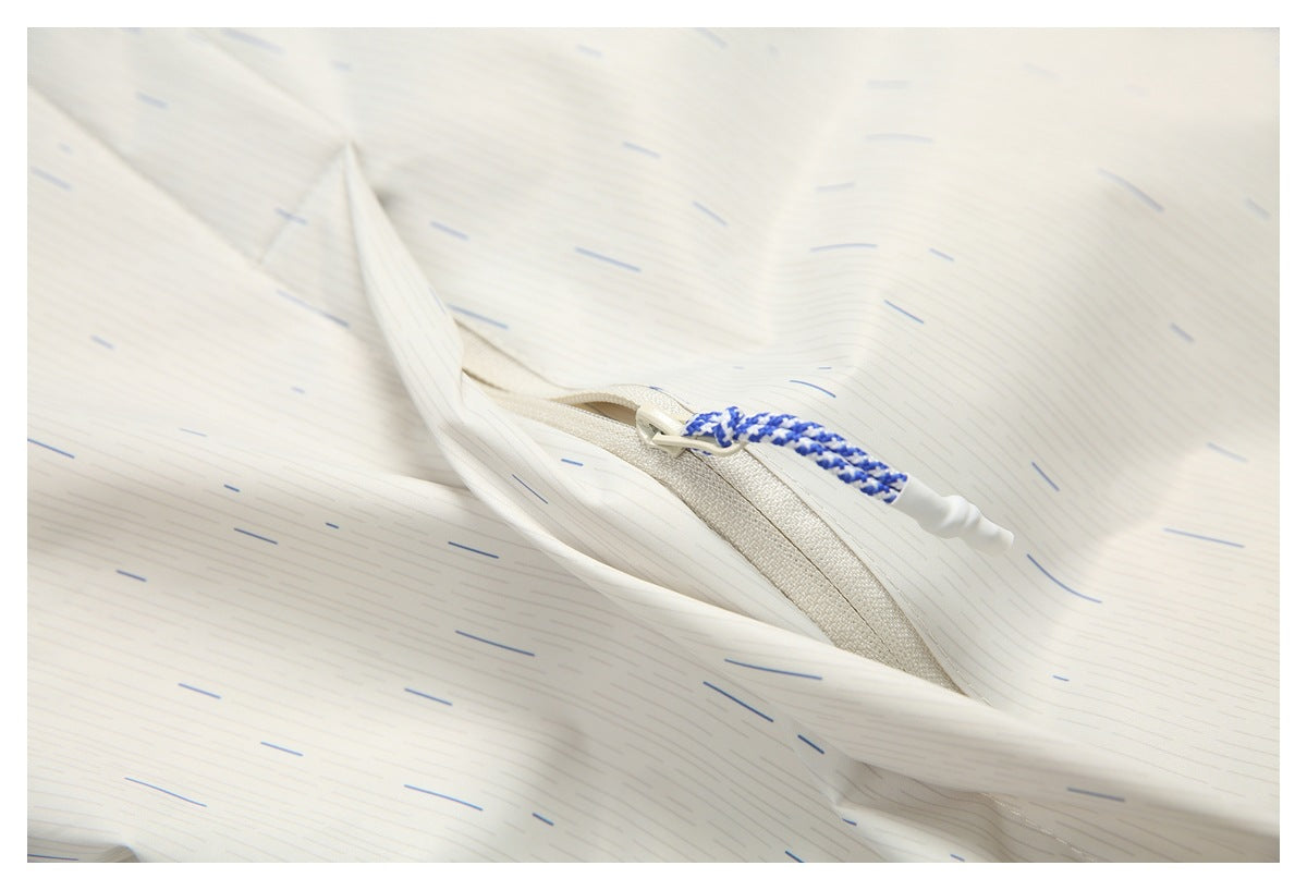 Close-up of a zippered pocket with a blue-and-white braided pull on an off-white garment patterned with fine dashes.