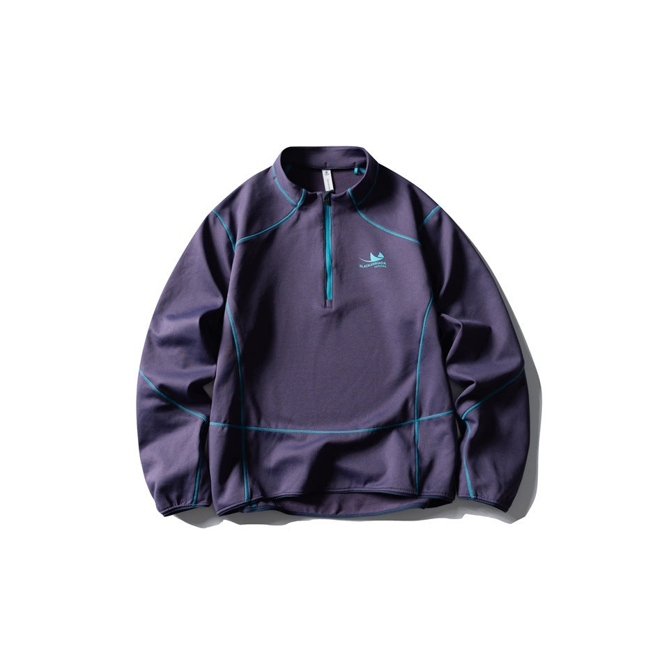 Dark purple half-zip pullover flat lay with bright teal contrast stitching and zipper
