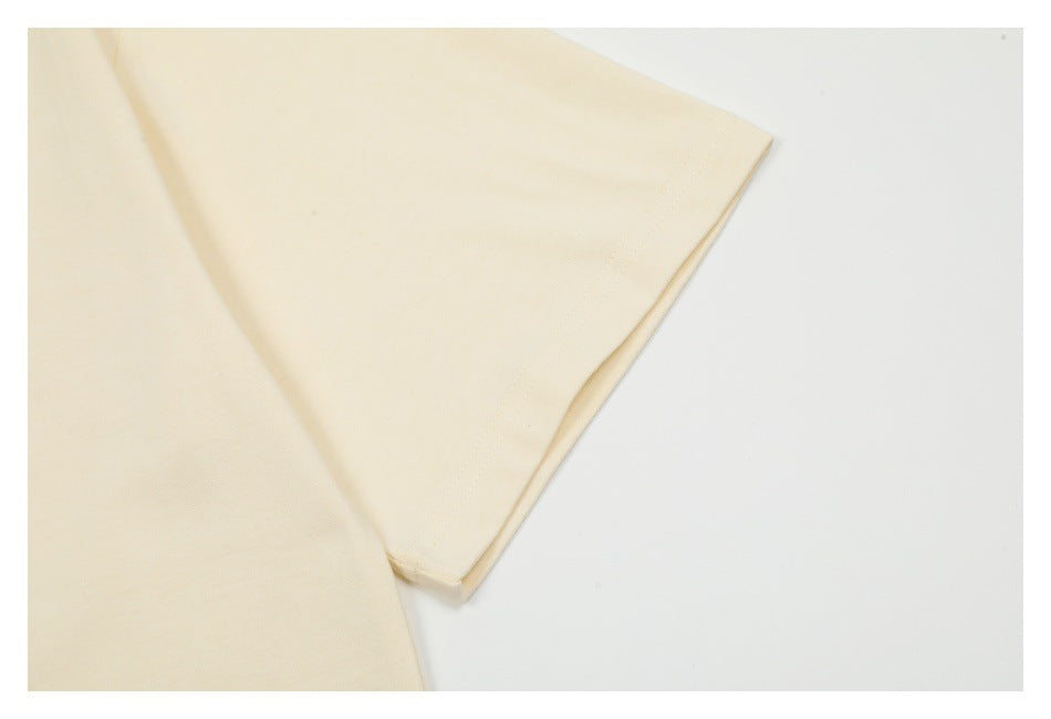 Close-up of the off-white T-shirt's short sleeve and stitched edge.