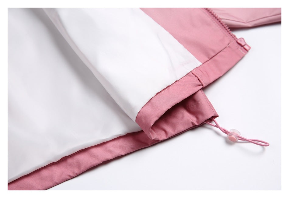 Close-up of a pale pink and white garment cuff and hem with a pink drawcord loop.