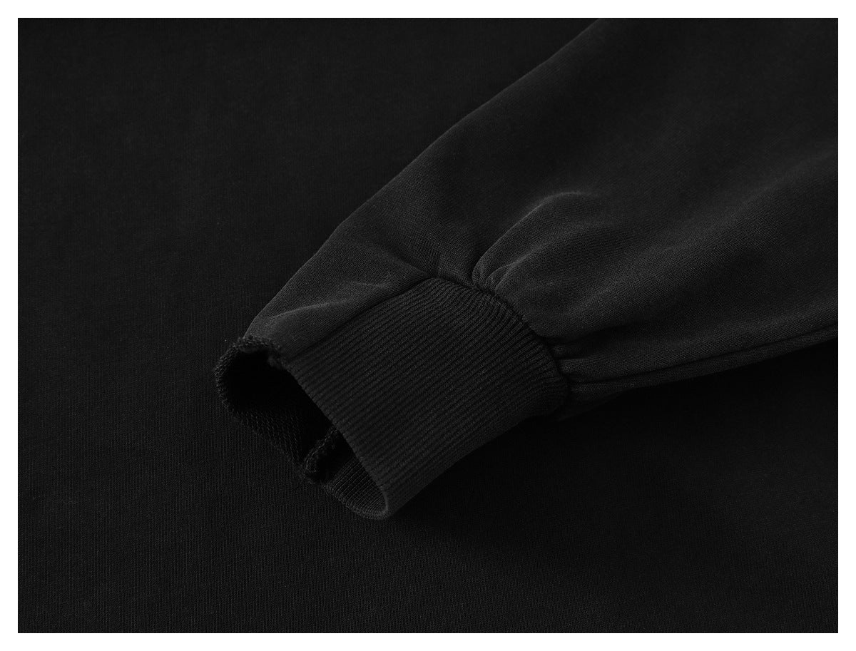 Close-up of a black sweatshirt sleeve ending in a ribbed cuff.