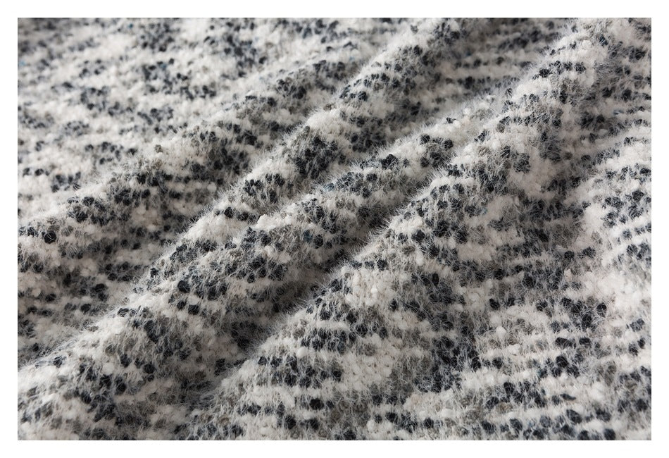 Macro view of the garment's soft-looking black-and-white textured pattern.